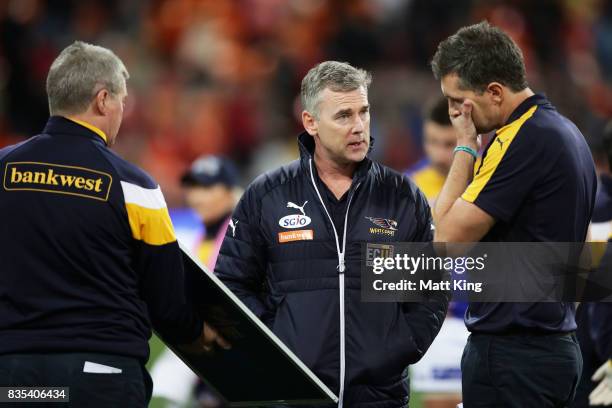 Eagles head coach Adam Simpson speaks to coaches at three quarter time during the round 22 AFL match between the Greater Western Sydney Giants and...