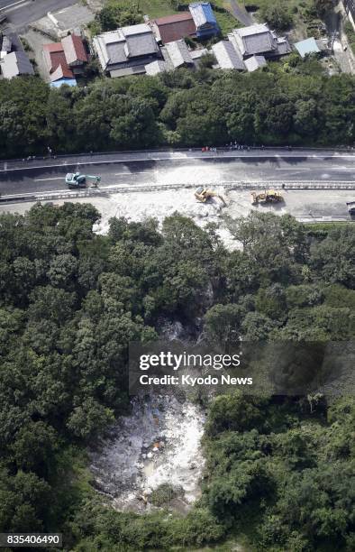 Photo taken Aug. 19 from a Kyodo News helicopter shows the scene of a landslide on the Chuo Expressway in Mizunami, Gifu Prefecture, central Japan....