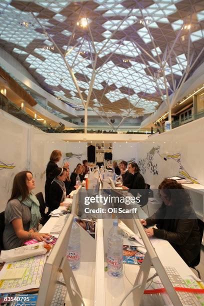 Production staff on the weekly fashion magazine, Grazia edit the magazine in a temporary office inside the Westfield shopping centre on November 3,...