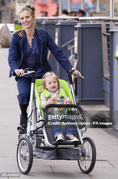 Model Laura Bailey and 3-year-old Cameron Willen, demonstrate Taga, the innovative new Dutch eco-stroller-bike concept, at the UK launch on London's...
