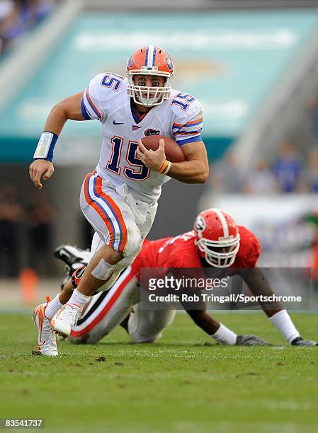 Quarterback Tim Tebow of the Florida Gators runs with the ball against the Georgia Bulldogs at Jacksonville Municipal Stadium on November 1, 2008 in...
