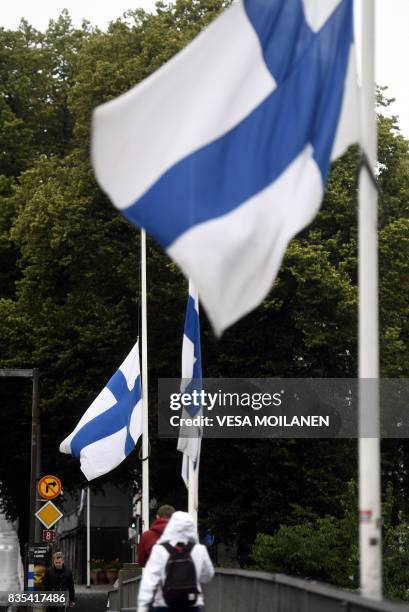 Finnish flags fly at half-mast in Turku, Finland on August 19, 2017. - Two people were killed and six were injured in a stabbing spree in the Finnish...