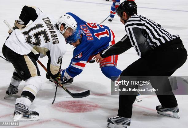 Linesman Pierre Racicot drops the puck during a faceoff between Scott Gomez of the New York Rangers and Mike Zigomanis of the Pittsburgh Penguins on...