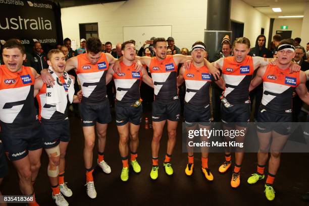 Giants players celebrate victory and sing the club song after the round 22 AFL match between the Greater Western Sydney Giants and the West Coast...