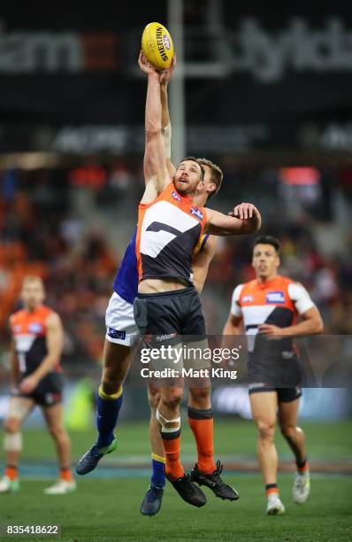 Shane Mumford of the Giants is challenged by Nathan Vardy of the Eagles during the round 22 AFL match between the Greater Western Sydney Giants and...