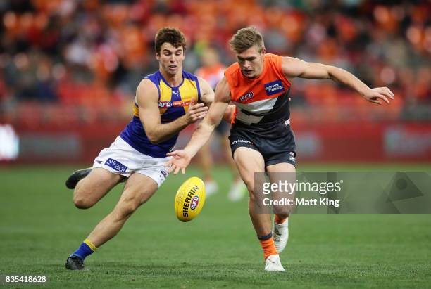 Adam Tomlinson of the Giants is challenged by Jamie Cripps of the Eagles during the round 22 AFL match between the Greater Western Sydney Giants and...