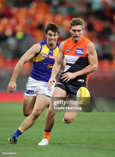 Adam Tomlinson of the Giants is challenged by Jamie Cripps of the Eagles during the round 22 AFL match between the Greater Western Sydney Giants and...