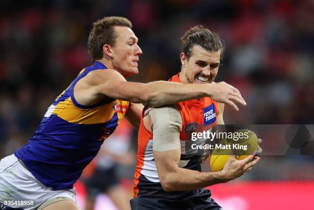 Phil Davis of the Giants is challenged by Drew Petrie of the Eagles during the round 22 AFL match between the Greater Western Sydney Giants and the...