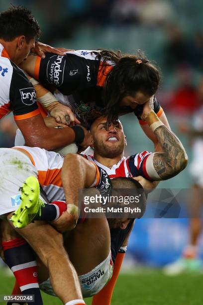Blake Ferguson of the Roosters is tackled by Aaron Woods of the Tigers during the round 24 NRL match between the Sydney Roosters and the Wests Tigers...