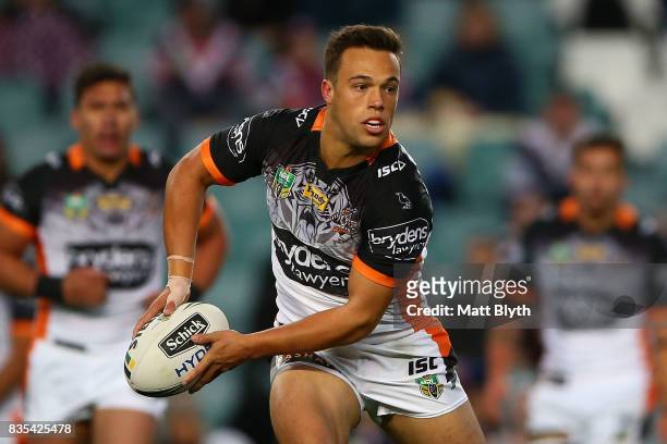 Luke Brooks of the Tigers passes the ball during the round 24 NRL match between the Sydney Roosters and the Wests Tigers at Allianz Stadium on August...
