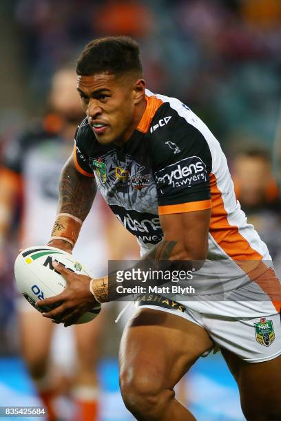 Michael Chee Kam of the Tigers runs the ball during the round 24 NRL match between the Sydney Roosters and the Wests Tigers at Allianz Stadium on...