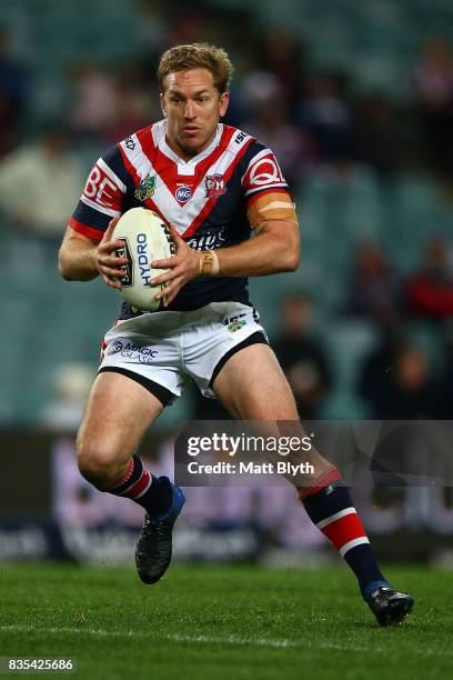 Mitchell Aubusson of the Roosters runs the ball during the round 24 NRL match between the Sydney Roosters and the Wests Tigers at Allianz Stadium on...