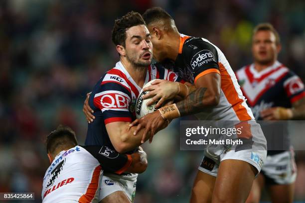 Aidan Guerra of the Roosters is tackled during the round 24 NRL match between the Sydney Roosters and the Wests Tigers at Allianz Stadium on August...