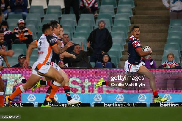 Latrell Mitchell of the Roosters makes a break during the round 24 NRL match between the Sydney Roosters and the Wests Tigers at Allianz Stadium on...