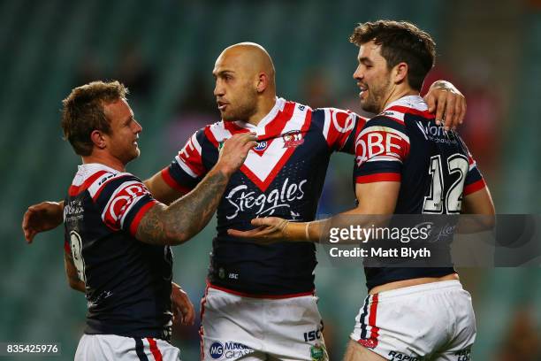 Aidan Guerra of the Roosters is congratulated by Blake Ferguson and Jakob Friend of the Roosters after scoring a try during the round 24 NRL match...