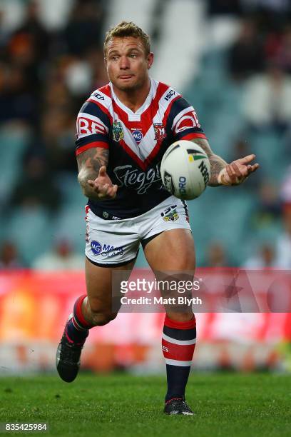 Jakob Friend of the Roosters passes the ball during the round 24 NRL match between the Sydney Roosters and the Wests Tigers at Allianz Stadium on...