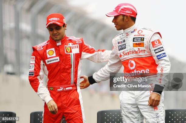 Championship rivals Felipe Massa of Brazil and Ferrari and Lewis Hamilton of Great Britain and McLaren Mercedes shake hands at the drivers end of...