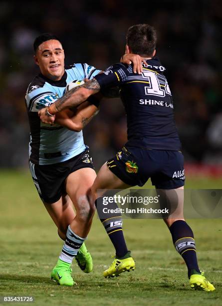 Valentine Holmes of the Sharks is tackled by Benjamin Hampton of the Cowboys during the round 24 NRL match between the North Queensland Cowboys and...