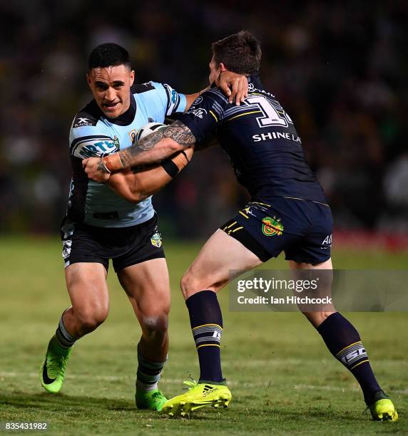 Valentine Holmes of the Sharks is tackled by Benjamin Hampton of the Cowboys during the round 24 NRL match between the North Queensland Cowboys and...