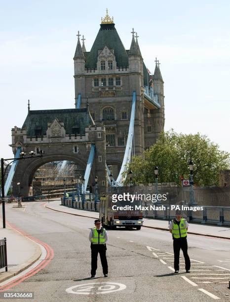 Police keep the road on London's Tower Bridge closed as a fire engine leaves the scene of an elevator accident in the north tower of the structure,...