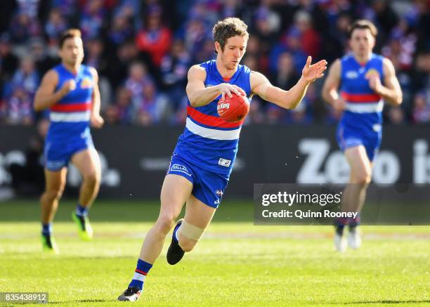 Robert Murphy of the Bulldogs kicks during the round 22 AFL match between the Western Bulldogs and the Port Adelaide Power at Mars Stadium on August...