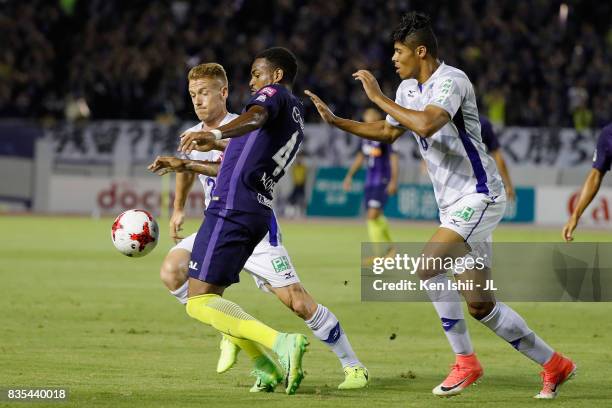 Anderson Lopes of Sanfrecce Hiroshima controls the ball under pressure of Oliver Bozanic and Eder Lima of Ventforet Kofu during the J.League J1 match...
