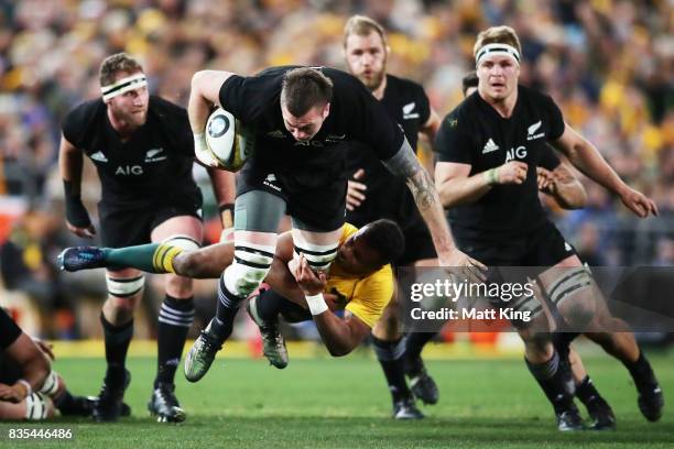 Liam Squire of the All Blacks is tackled by Will Genia of the Wallabies during The Rugby Championship Bledisloe Cup match between the Australian...