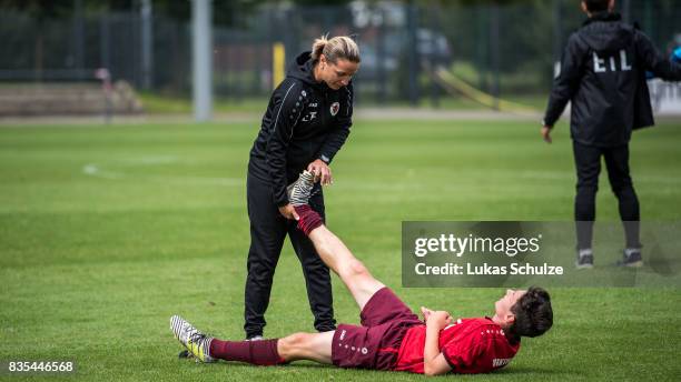Head Coach Inka Grings helps Can Karaguemrueklue of Koeln during the B Juniors Bundesliga match between Borussia Dortmund and FC Viktoria Koeln on...
