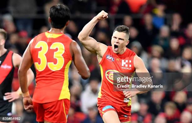 Ben Ainsworth of the Suns celebrates after kicking a goal during the round 22 AFL match between the Gold Coast Suns and the Essendon Bombers at...