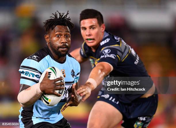 James Segeyaro of the Sharks gets away from Shane Wright of the Cowboys during the round 24 NRL match between the North Queensland Cowboys and the...
