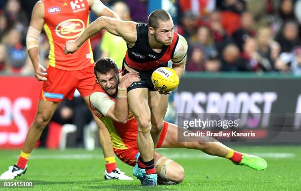 David Zaharakis of the Bombers is pressured by the defence during the round 22 AFL match between the Gold Coast Suns and the Essendon Bombers at...