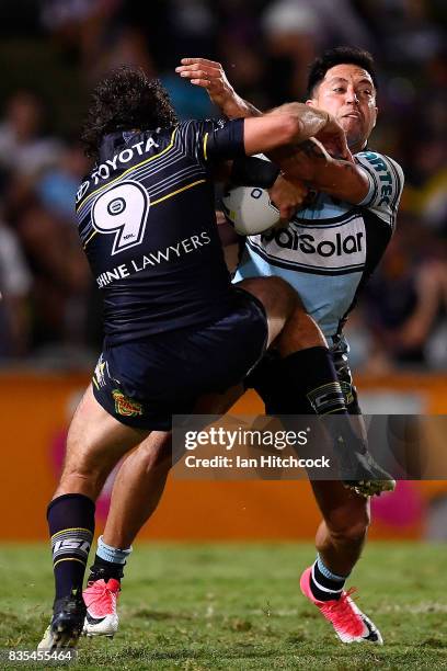 Gerard Beale of the Sharks is tackled by Jake Granville of the Cowboys during the round 24 NRL match between the North Queensland Cowboys and the...