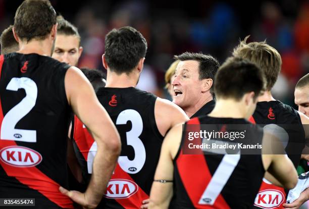 Coach John Worsfold of the Bombers talks to his players at the 3rd quarter time break during the round 22 AFL match between the Gold Coast Suns and...