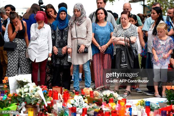 Muslim residents of Barcelona pay tribute at the Canaletas fountain during a demonstration on the Las Ramblas boulevard in Barcelona, to protest...