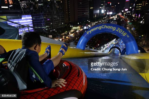 South Korean child slides down on an inflatable ring during the 'Bobsleigh In the City' on August 19, 2017 in Seoul, South Korea. The 22-metre-high...