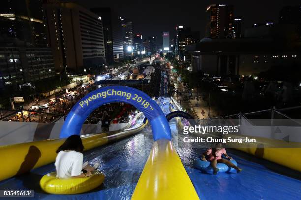 South Korean girls slide down on an inflatable ring during the 'Bobsleigh In the City' on August 19, 2017 in Seoul, South Korea. The 22-metre-high...