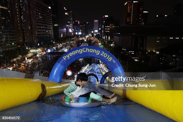 South Korean boy slides down on an inflatable ring during the 'Bobsleigh In the City' on August 19, 2017 in Seoul, South Korea. The 22-metre-high...