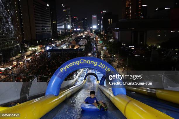 South Korean child slides down on an inflatable ring during the 'Bobsleigh In the City' on August 19, 2017 in Seoul, South Korea. The 22-metre-high...