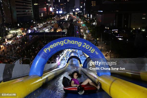 South Korean woman slides down on an inflatable ring during the 'Bobsleigh In the City' on August 19, 2017 in Seoul, South Korea. The 22-metre-high...