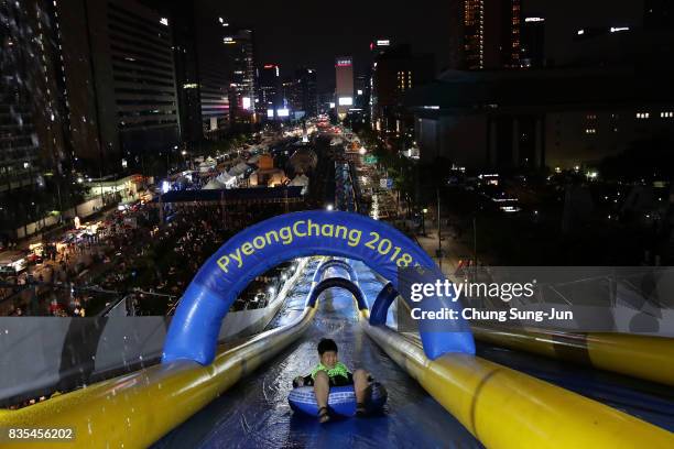 South Korean child slides down on an inflatable ring during the 'Bobsleigh In the City' on August 19, 2017 in Seoul, South Korea. The 22-metre-high...