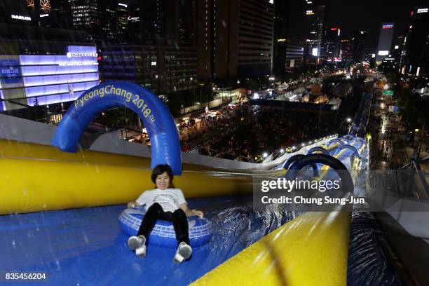 South Korean woman slides down on an inflatable ring during the 'Bobsleigh In the City' on August 19, 2017 in Seoul, South Korea. The 22-metre-high...