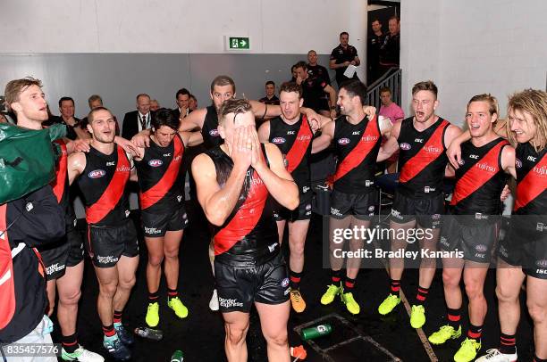 The Bombers celebrate their victory after the round 22 AFL match between the Gold Coast Suns and the Essendon Bombers at Metricon Stadium on August...