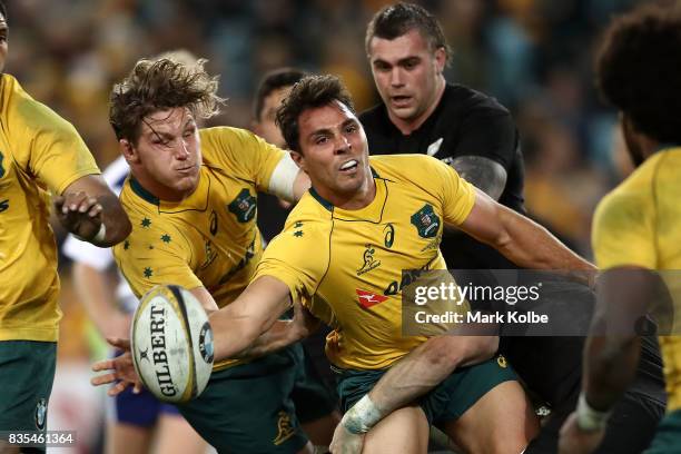 Nick Phipps of the Wallabies passes as he is tackled during The Rugby Championship Bledisloe Cup match between the Australian Wallabies and the New...