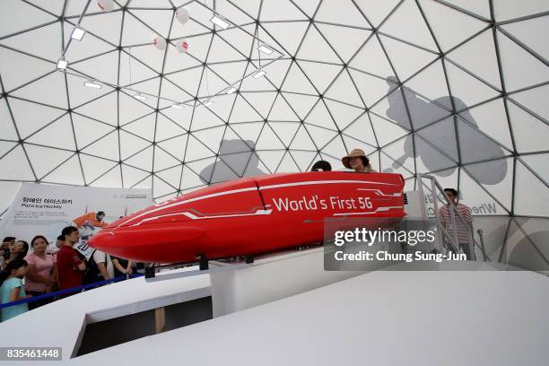 People enjoy the PyeongChang Winter Olympics booth next to 'Bobsleigh In the City' event on August 19, 2017 in Seoul, South Korea. The 22-metre-high...