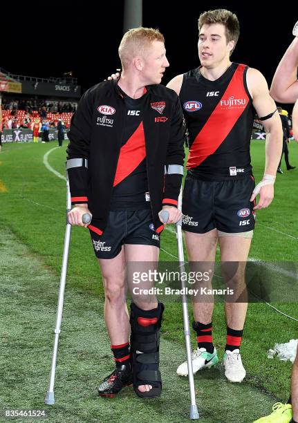 Josh Green of the Bombers is seen in crutches after being injured during the round 22 AFL match between the Gold Coast Suns and the Essendon Bombers...