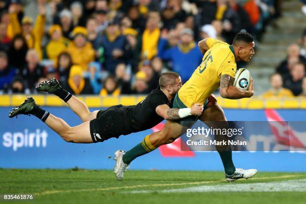 Israel Folau of the Wallabies heads to the try line to score as TJ Perenara of the All Blacks dives to tackle him during The Rugby Championship...