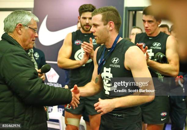 Sam Docherty of the Blues is presented with the David Parkin medal during the round 22 AFL match between the Carlton Blues and the Hawthorn Hawks at...