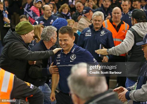 Blues head coach Brendon Bolton smiles as he walks through supporters in the crowd after the Blues won the round 22 AFL match between the Carlton...