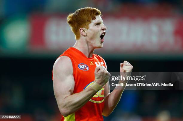 Josh Schoenfeld of the Suns celebrates a goal during the round 22 AFL match between the Gold Coast Suns and the Essendon Bombers at Metricon Stadium...