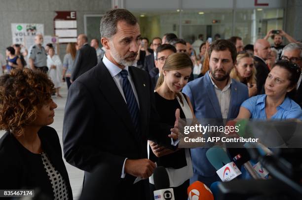 Spain's King Felipe VI and Queen Letizia talk to the press at the Sant Pau hospital in Barcelona after visiting victims of the Barcelona attack on...